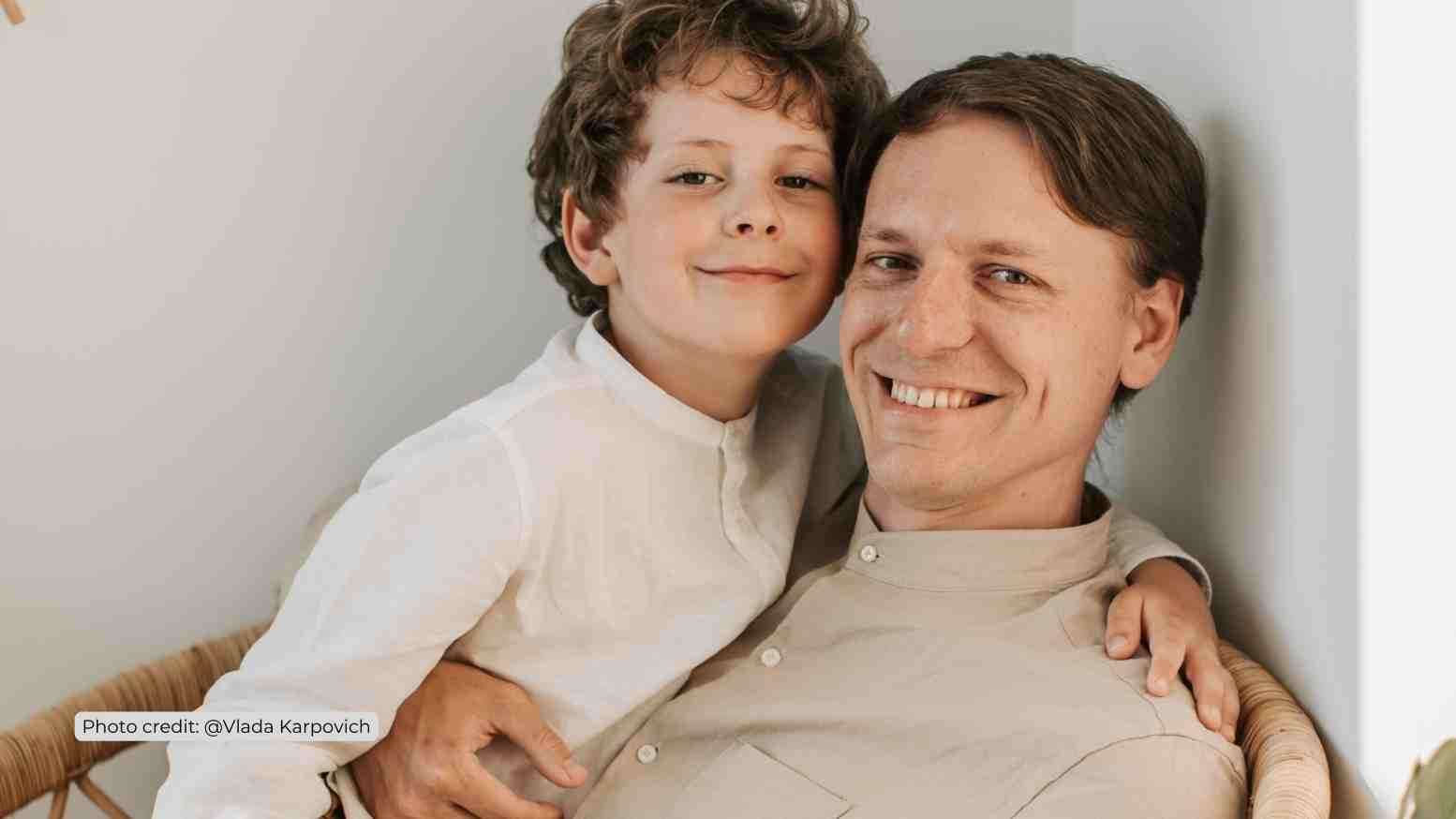 Father and son smiling at camera