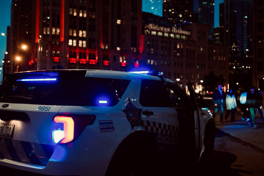 Police car with flashing lights in city at night